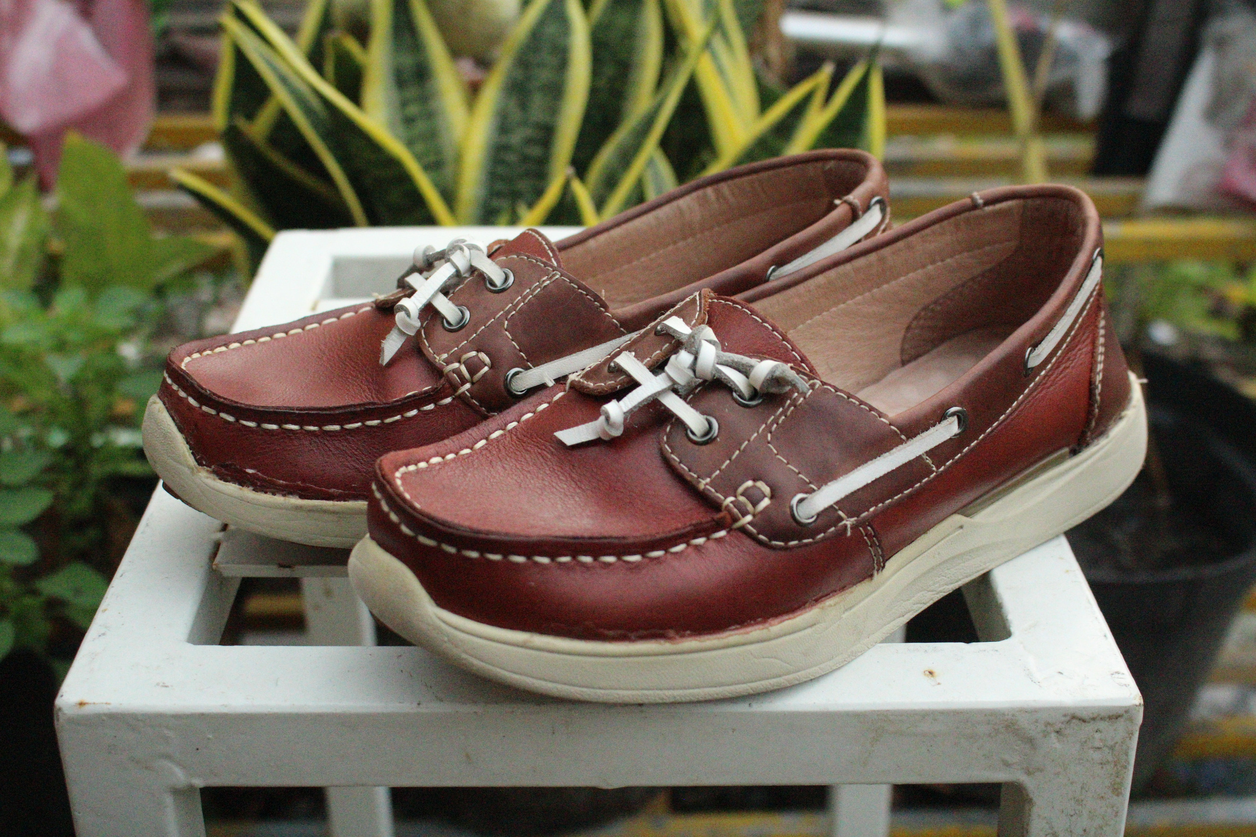 Premium leather dress shoes transformation from scuffed and dull brown leather to polished glossy finish with restored color and shine after professional leather cleaning service